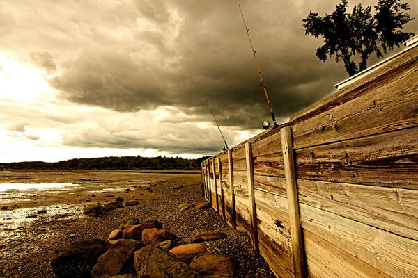 Fishing on the sea behind the fence