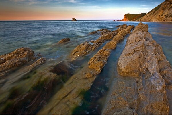 Sunrise from the rocks over the calm sea