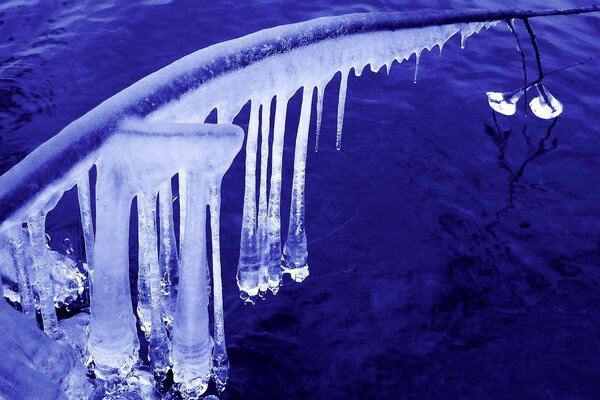 Icicles and ice near water in winter