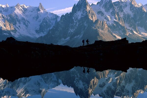 The mountain landscape is reflected in the lake