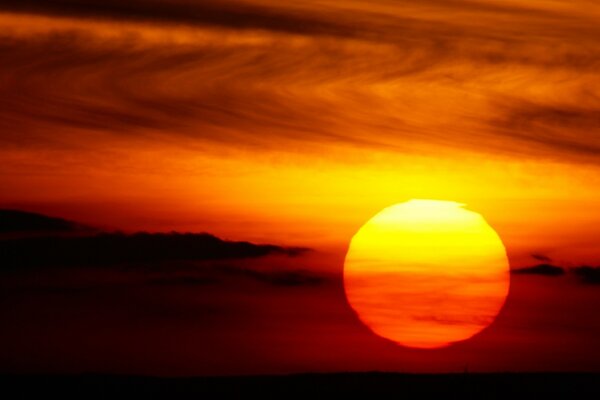 The setting sun among cirrus clouds