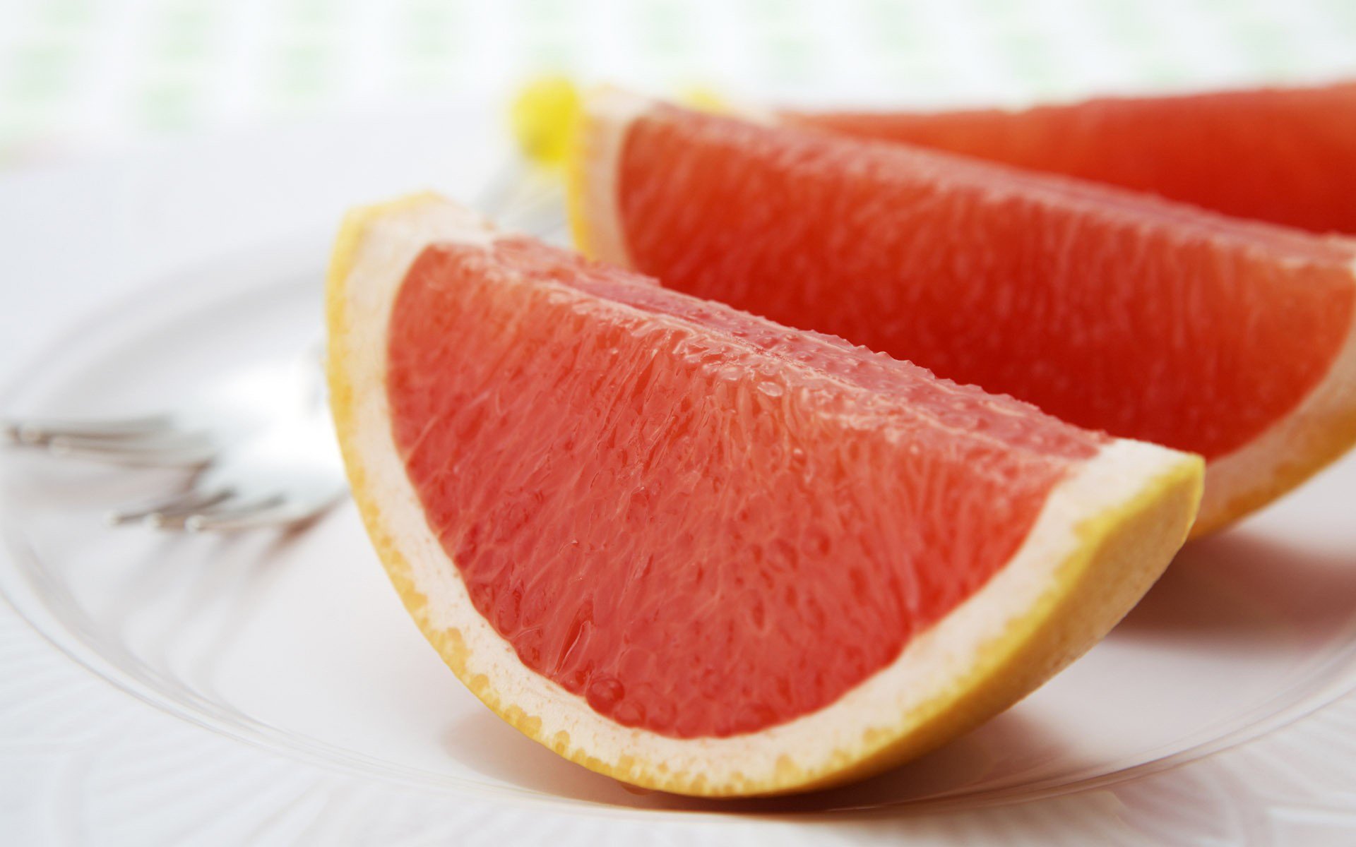 grapefruit citrus white background macro plate slice