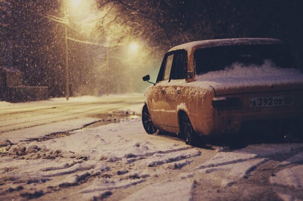 Yellow penny Zhiguli in the snow