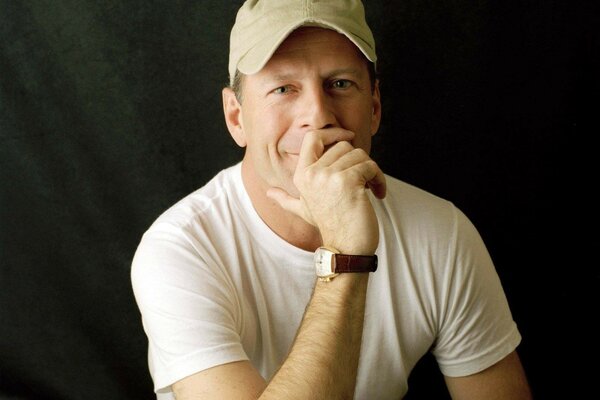 A man in a white T-shirt and a cap