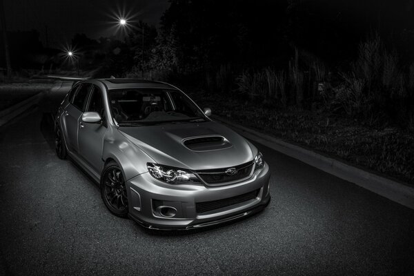 Racing in the middle of a gloomy night on a gray car