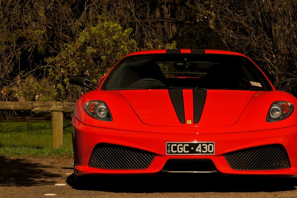 Supercar ferrari scuderia f430 red with a beautiful view