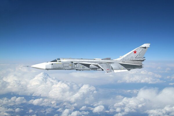 The Su-24 bomber flies in the sky above the clouds