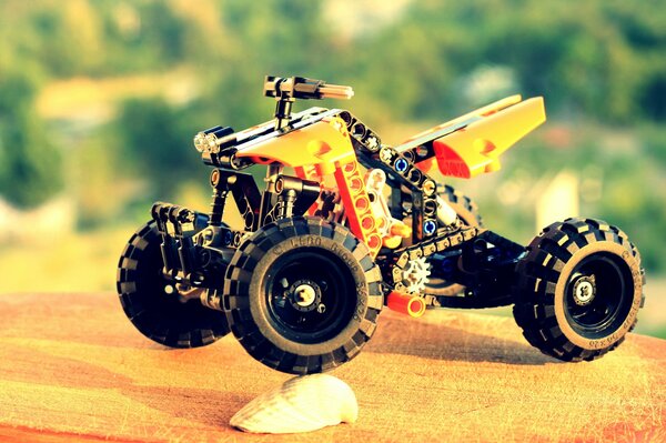 Orange toy quad bike made of lego