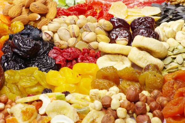 There are a lot of dried fruits in the photo. Nuts, candied fruits and dried fruits. Dried Fruit Market