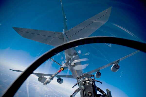 Refueling hose of an airplane against the sky