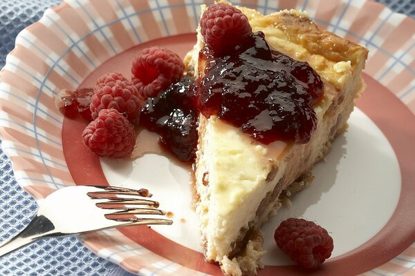 A piece of pie with berry jam and raspberries