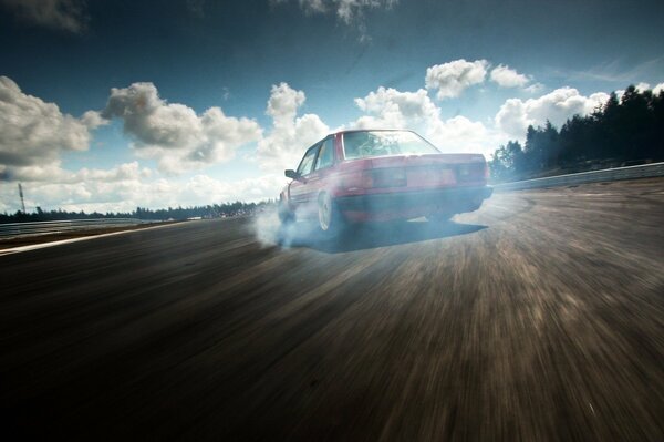 BMW drift on the highway under a cloudy sky on an empty road