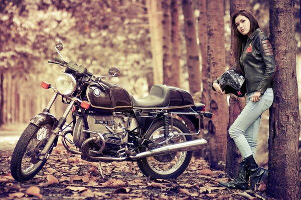 A girl stands next to a BMW motorcycle