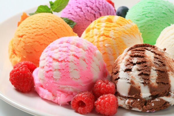 Assorted ice cream with berries on a white plate