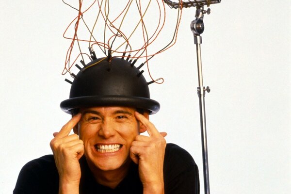 Jim Carrey in a black helmet with wires