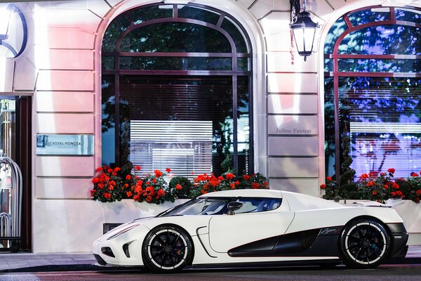 Sports car on the background of a building with flowers