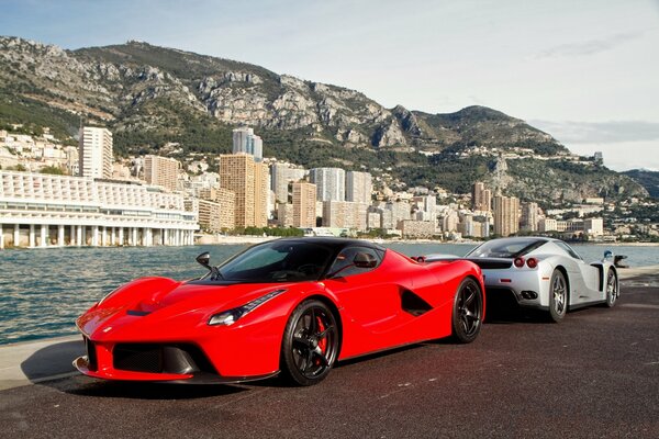 A red Ferrari car on the background of the buildings of the city