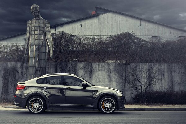 Bmw x6 e72 hamann on the background of an abandoned building