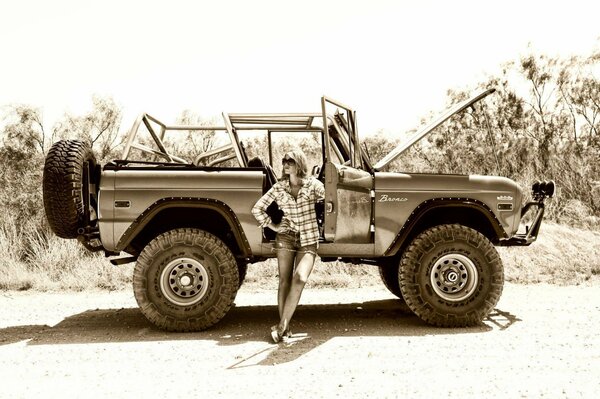 Black and white photos of a girl on the background of a car