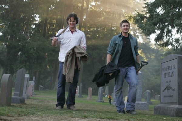 The Winchester brothers from Supernatural Walk through the cemetery