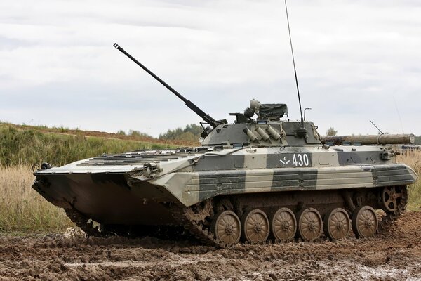 BMP 2 at Russian military exercises, and around the trench from tracks of caterpillars