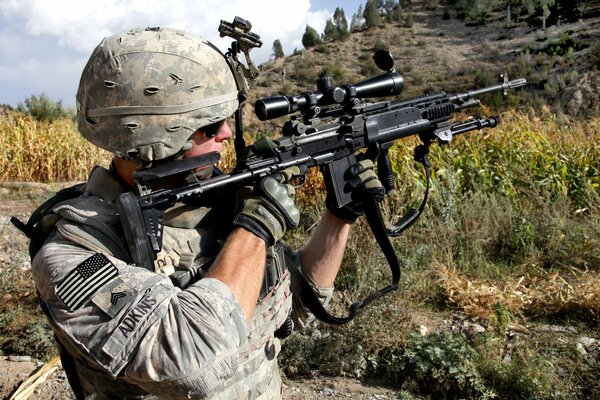 An American soldier takes aim with a sniper rifle
