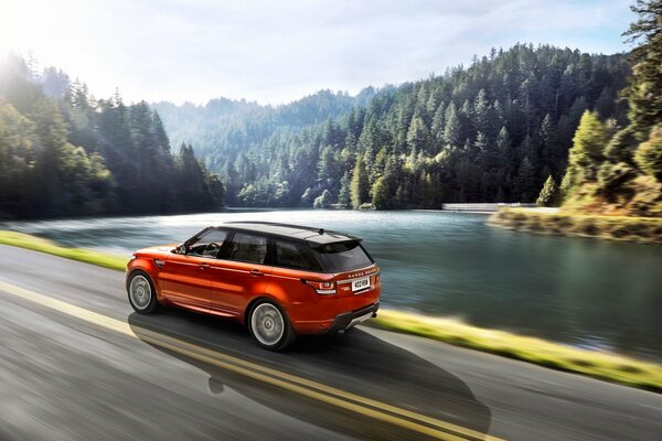 Forest landscape with lake and Land rover sport side view