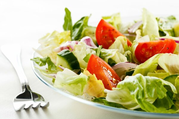 Vegetable salad with tomato and lettuce leaves