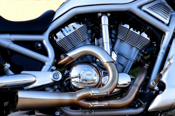 Chrome pipes of a Harley Davidson motorcycle close-up