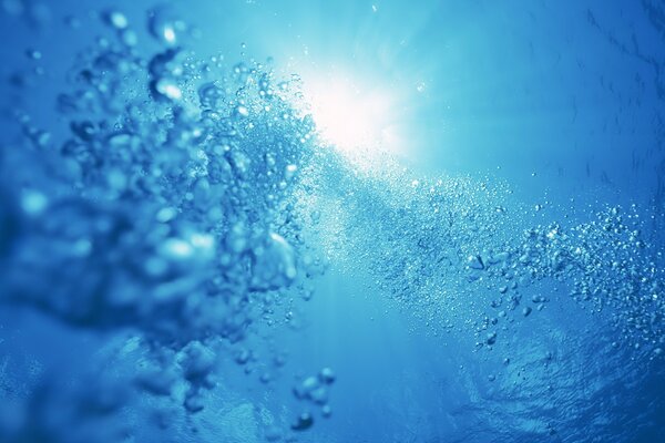 A beam of light through water bubbles