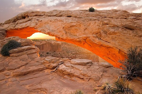 Arch in the canyon flooded with the sun