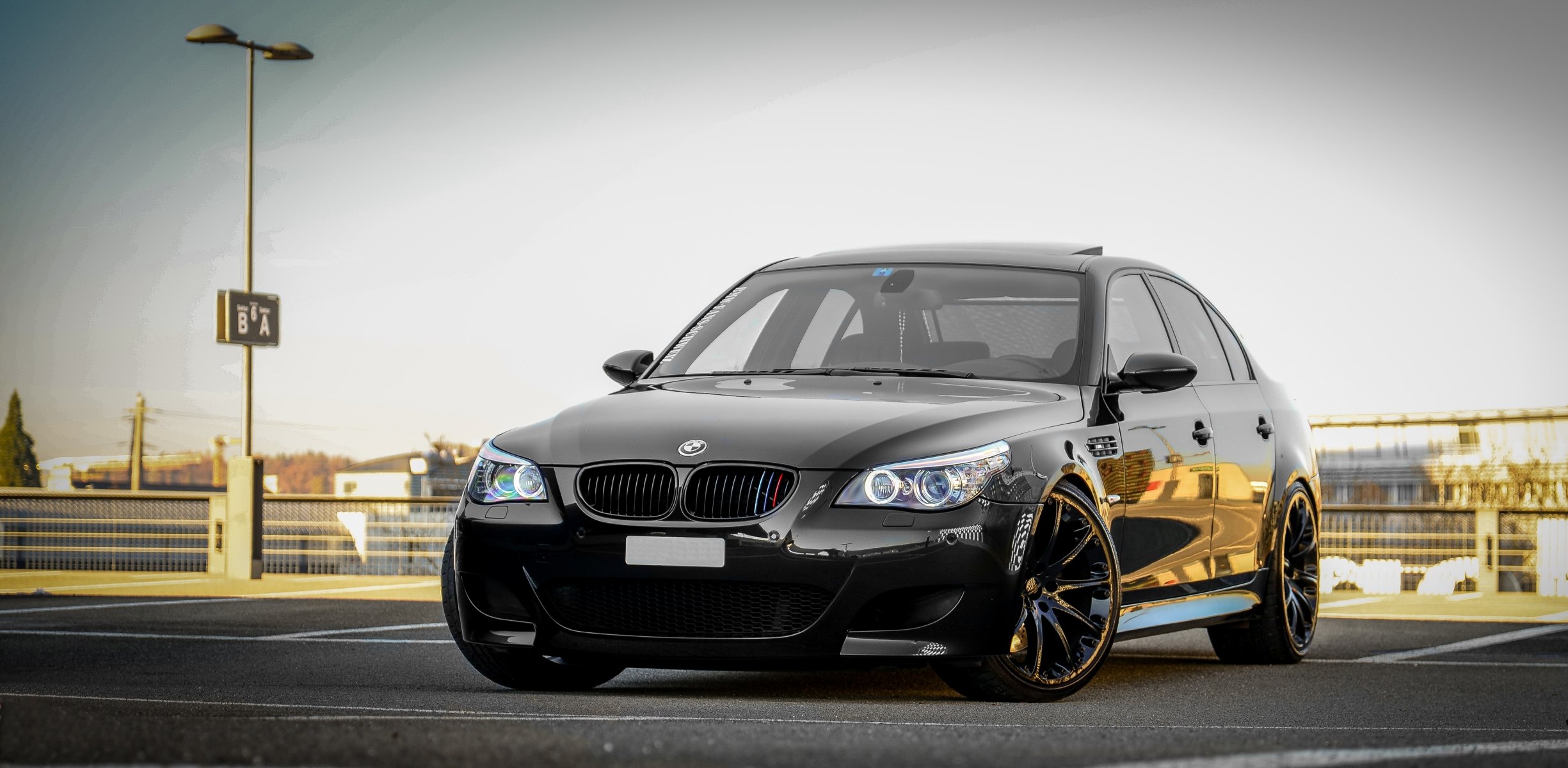 bmw m5 e60 black bmw sedan parking sky