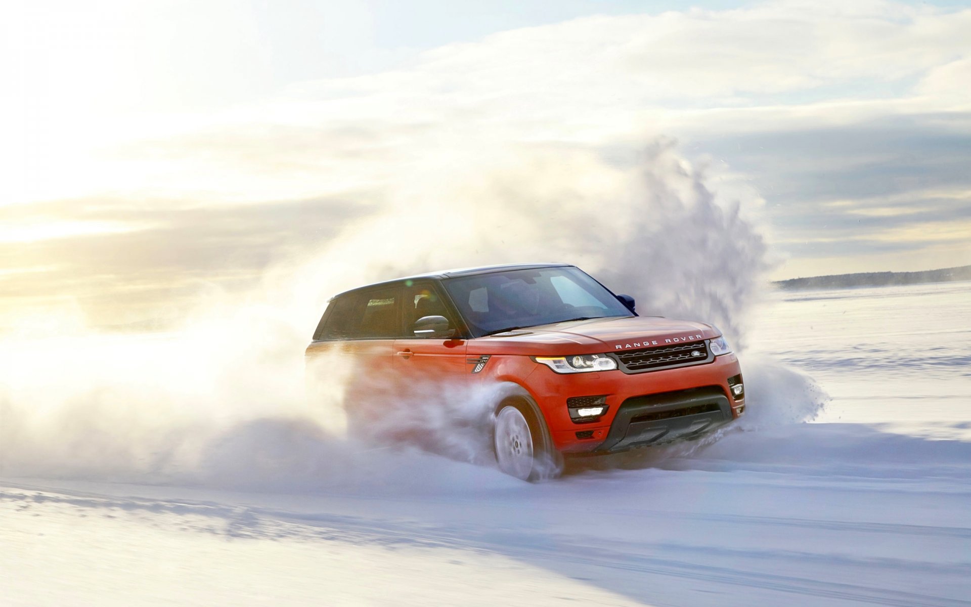 land rover range rover sport rosso neve inverno velocità in movimento giorno sole