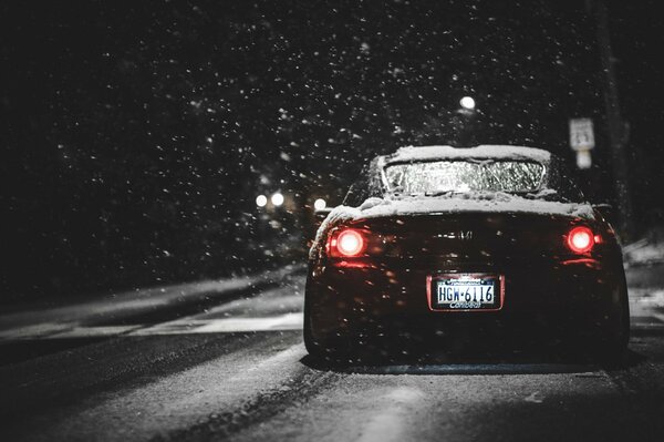 Honda S2000 on a snowy street. Rear view