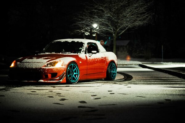 Orange Honda S2000 on a snowy street