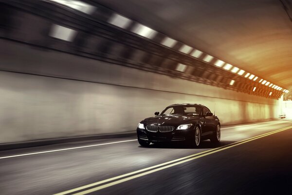 At a wild speed through the tunnel black BMW , beautiful