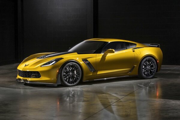 Yellow chevrolet corvette z06 on a black wall background