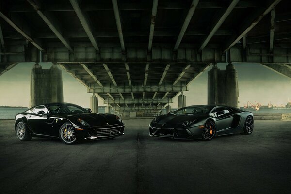 Two Lamborghini and Ferrari supercars gathered in the city under the bridge