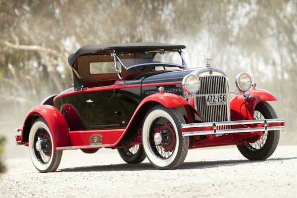 Classic red roadster on a country road