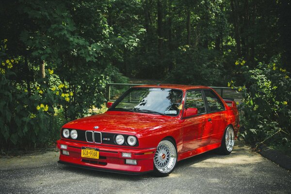 A tuned red car in the forest