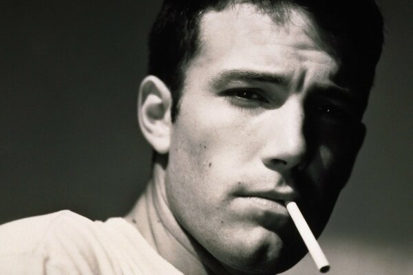Black and white photo of actor Ben Affleck with a cigarette in his teeth
