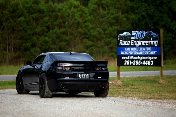 Black tuned Chevrolet with billboard