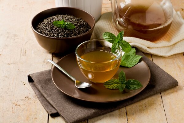 Tea in a beautiful cup with mint leaves