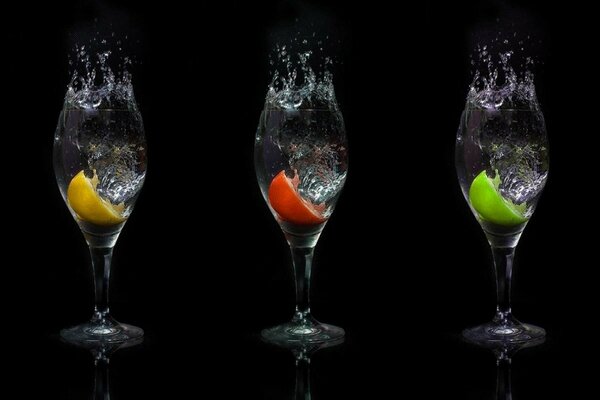 Three cocktail glasses with multicolored slices