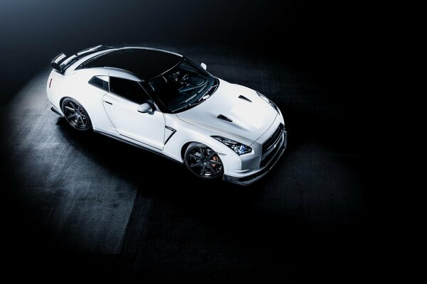 White nissan gt-r r35 on a black solid background