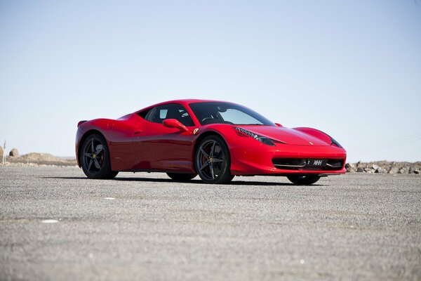 Photo of a red car on a gray asphalt background