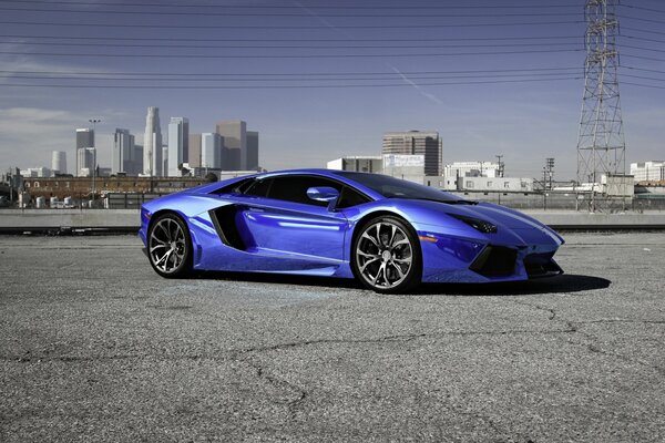 Blue Lamborghini on the asphalt on the background of the city