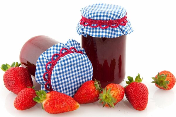 Jolis pots de confiture à côté des fraises fraîches