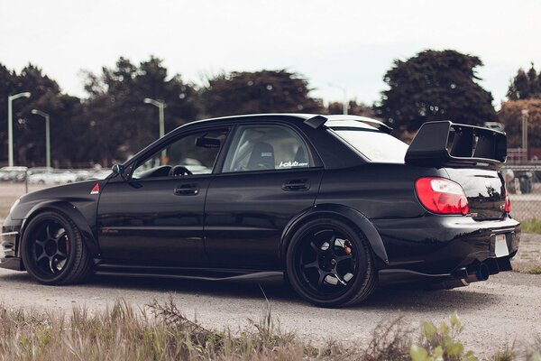 Tuned Subaru impreza on a background of trees