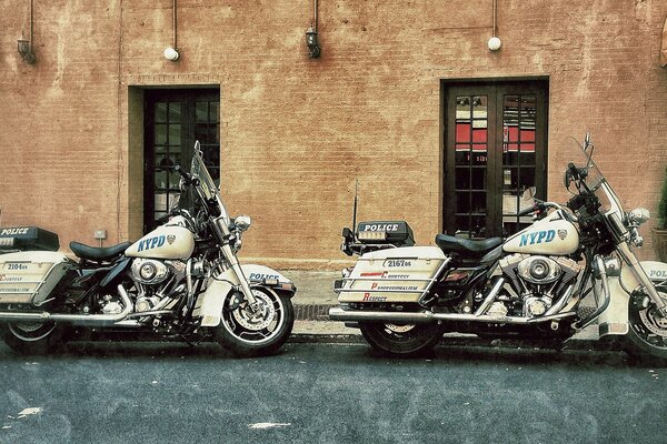 Police officers Harley dyvidsons on the street near the station